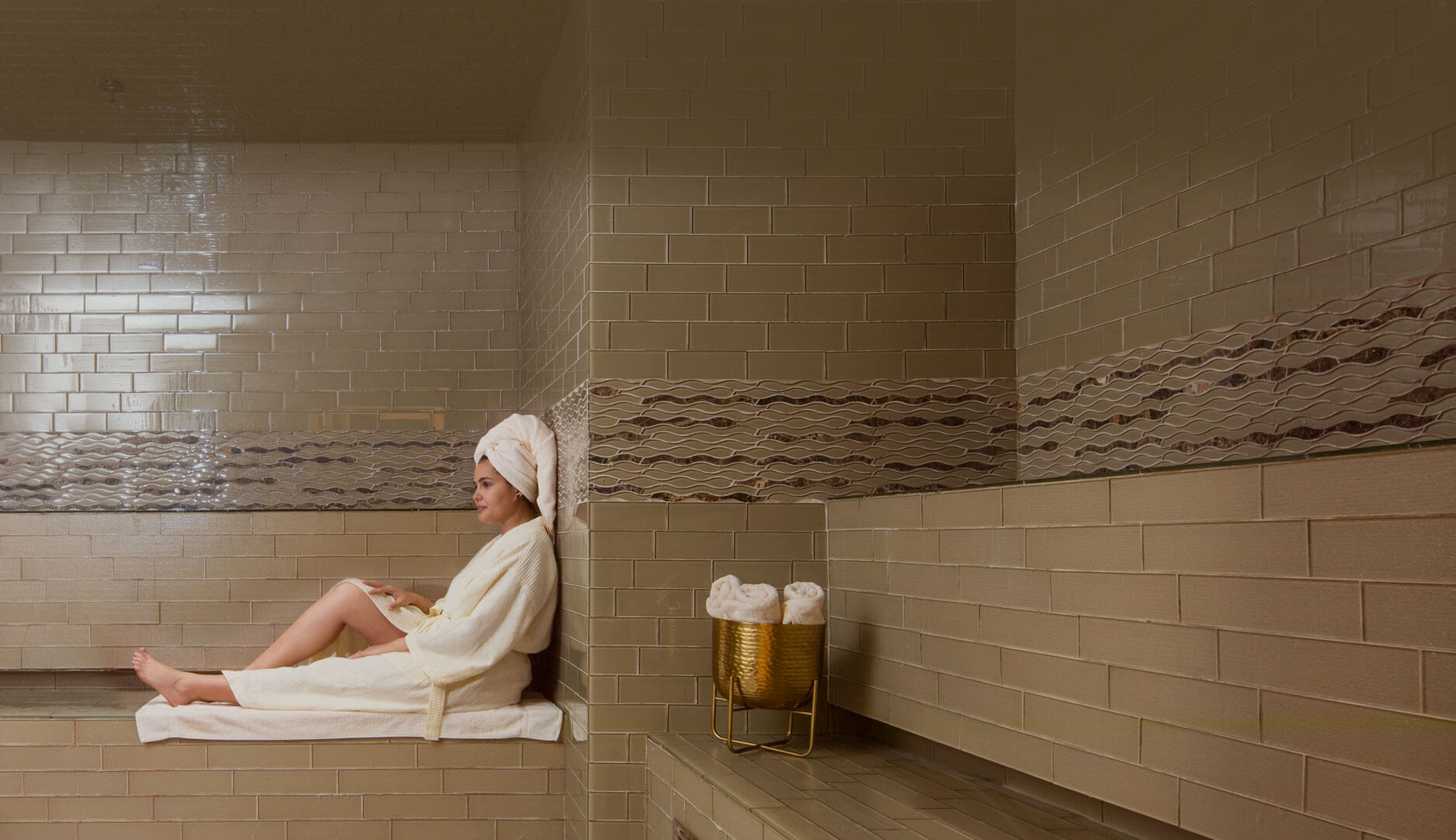 A woman sitting in the middle of a bath room